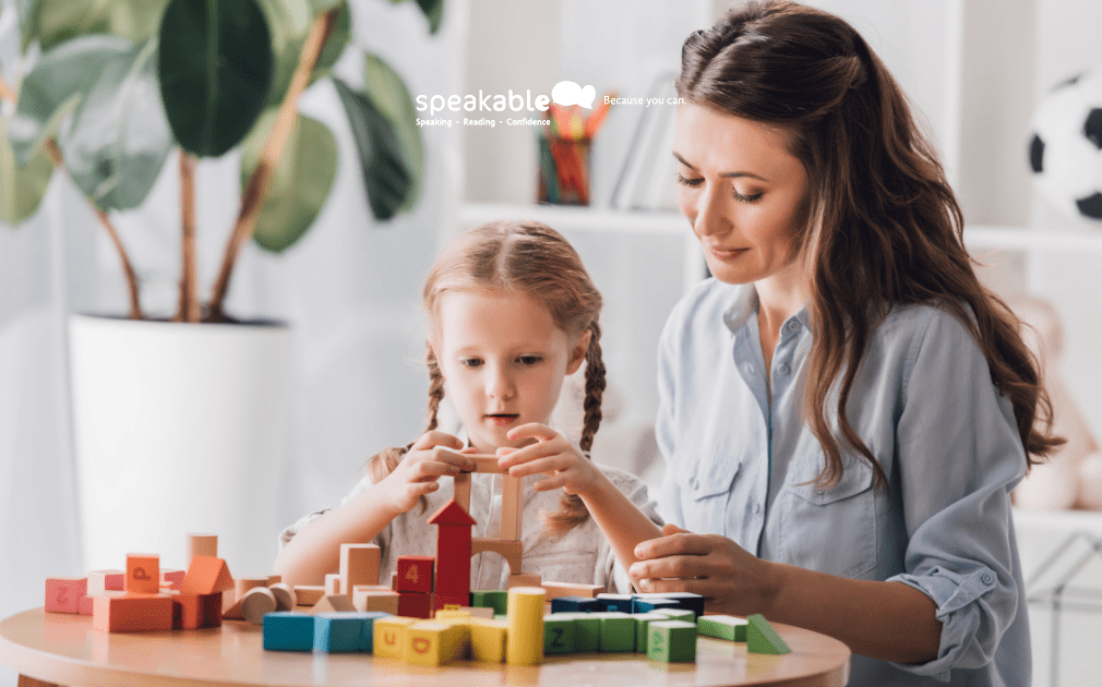 Parent engaging in play-based conversation with a toddler who is learning to talk.