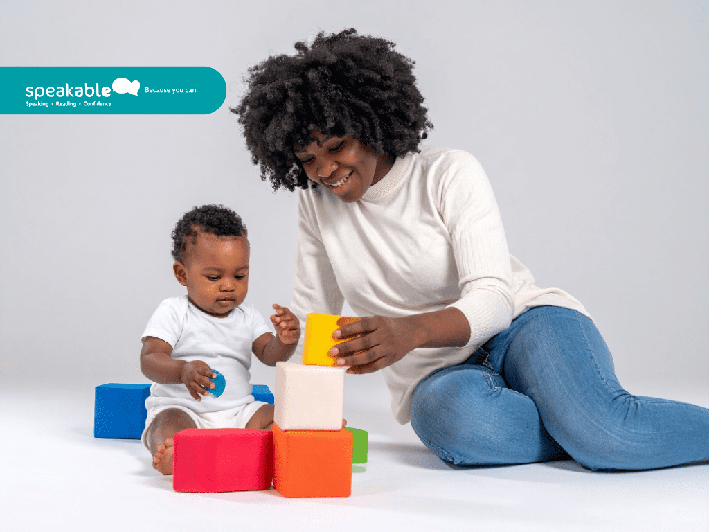 Parent and child laughing together during home speech practice.