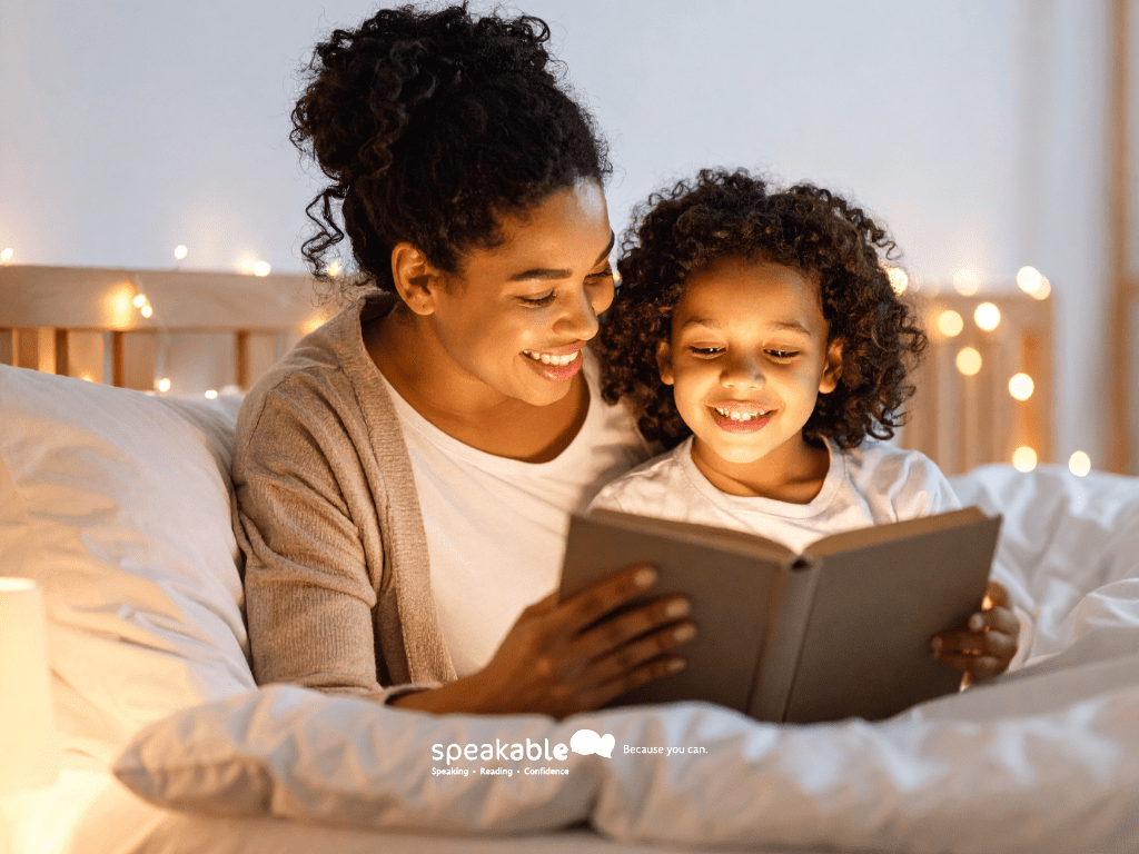 Child smiling while listening to a story with bright illustrations.