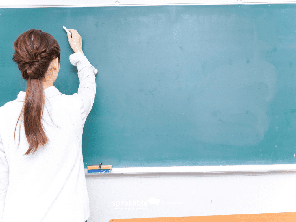 Teacher breaking classroom instructions into short, clear steps on the board.