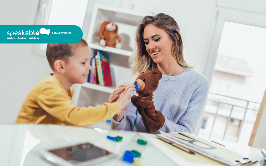 Child engaging in speech therapy while using visual supports to express ideas.