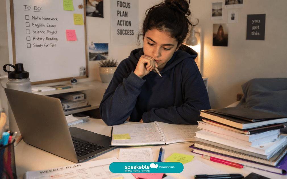 Teen organising schoolwork and planning next steps for a learning task.